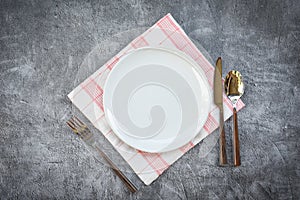 Place setting table food with set of white plate on table cloths or napkin on the dinner / empty plate spoon fork and knife on