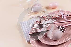 Place table setting and festive decor with easter eggs on beige background