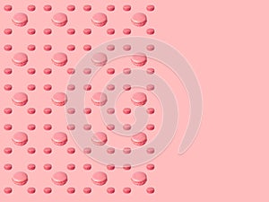 Place for text. Colorful pattern cakes macaroon on a pink background with copy space