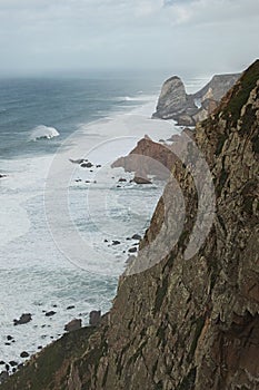 Place where the sea meets the land. High cliffs. Big waves and gusty winds. Cabo da Roca - rainy day.