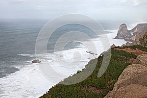 Place where the sea meets the land. High cliffs. Big waves and gusty winds. Cabo da Roca - rainy day.