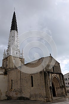 Place of worship with a bell tower and a clock on a French island