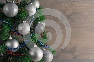 Place for your text, beautiful background with a decorated Christmas tree decorated with silver balls, copy space.