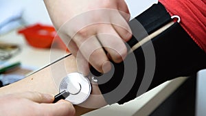 Placed straps of blood pressure measuring devices on the female hand