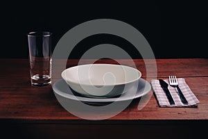 placed at the table with an empty plate, concept of poverty and economic crisis