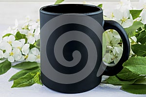 Placeit-Black coffee mug mockup with spring apple blossom
