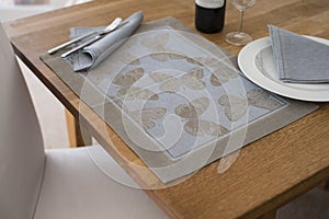 Placemat with Butterfly Design on Table with Napkin on Plate