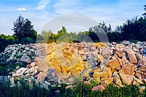 Placer of stone boulders among grass and trees photo