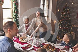 Placing food on the table for family Christmas dinner