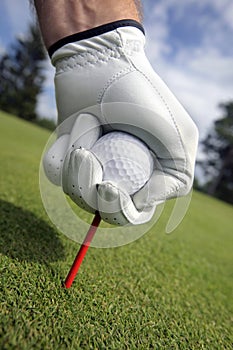 Placing golf ball on a tee