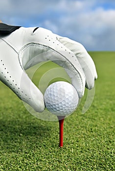 Placing golf ball on a tee