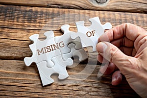 Placing missing a piece of puzzle. Business concept. Wooden background photo