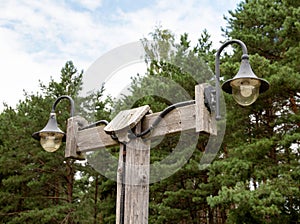 Plafond with lighting lamps in the village against the background of the forest. Copy space for text, traditional