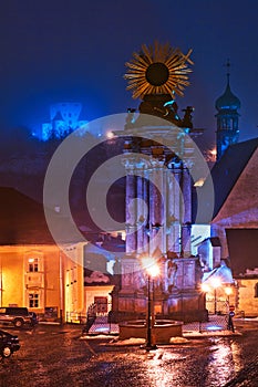 Plague pillar in Banska Stiavnica town during winter evening