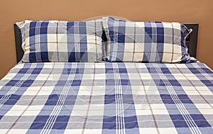 Plaid Bed with Pillow in The Bedroom