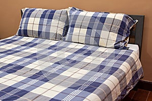 Plaid Bed with Pillow in The Bedroom