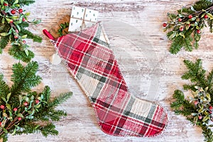 Plaid Christmas stocking and pine branches