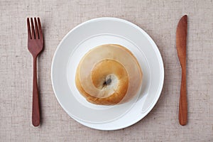 plain bagel bread on plate isolated on table cloth