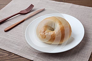 plain bagel bread on plate isolated on table cloth