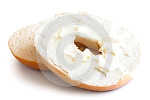 Plain bagel cut in half and spread with cream cheese. Isolated o