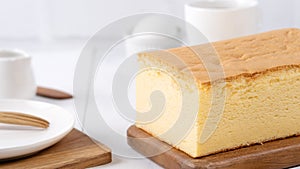 Plain classic Taiwanese traditional sponge cake Taiwanese castella kasutera on a wooden tray background table with ingredients,