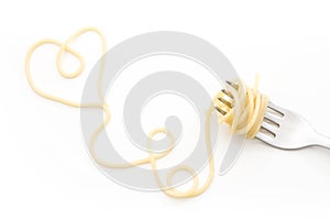 Plain cooked spaghetti pasta on fork with heart shape, on white background.