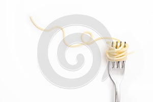 Plain cooked spaghetti pasta on fork with swirl, on white background.