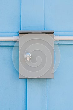 Plain Electric Control Enclosure on Blue Concrete Wall