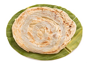 Plain paratha in a round shaped banana leaf isolated on white background photo