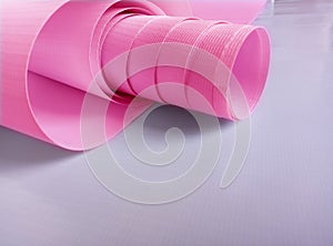 Plain pink flexion roll isolated on a white background