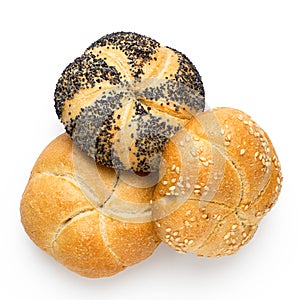 Plain, poppy seed amd sesame seed kaiser rolls isolated on white. Top view