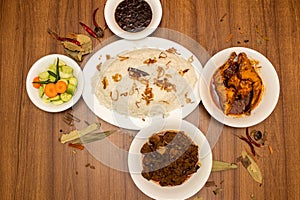 Plain rice with fried onion, beef rezala, korma, karahi, chicken korma, gravy, sauce and salad with red chilli served in dish