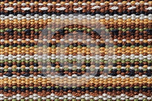 Plain weave fabric macro texture. Cloth background with horizontal strips of white, yellow, green, brown and black colors. Textile