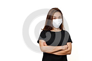 Plain white background with space for text. Asian lady wearing face mask for protection against coronavirus. Half body view young