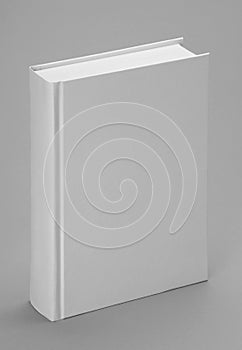 Plain white book standing with a grey backgound