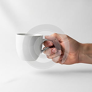 Plain white ceramic coffee mug against a neutral background. The mug has