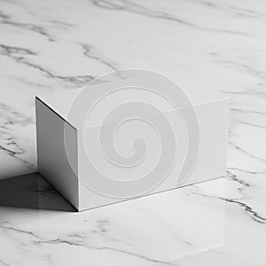 A plain white rectangular box placed on a white marble surface with