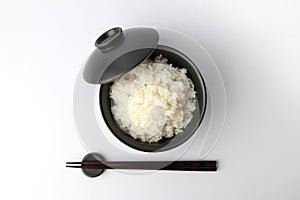 plain white rice in bowl with chopsticks isolated on white background