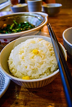 Plain White Rice in a Bowl with Chopsticks Placed Aside.