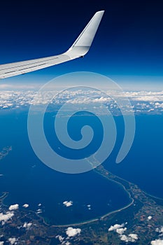 Plain wing over blue sky. Flight from Helsinki to Amsterdam