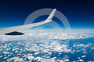 Plain wing over blue sky. Flight from Helsinki to Amsterdam