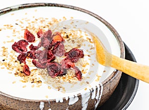 Plain yogurt with cranberry and black and white sesame topping