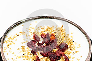 Plain yogurt with cranberry and black and white sesame topping