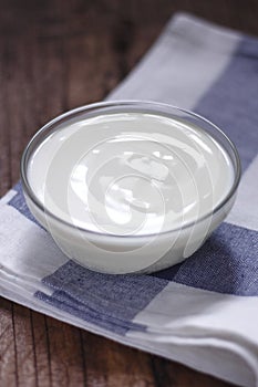 Plain yogurt in small glass bowl