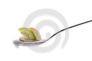Plain yogurt on a spoon with fresh fruits on top isolated on white background