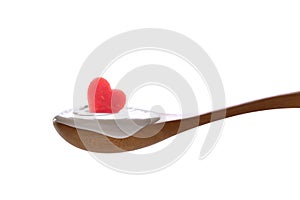 Plain yogurt on a spoon with fresh heart shape watermelon on top isolated on white background