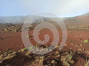 Plaine des sables in the morning : red volcanic sand and fog, barren desertic landscape, Reunion