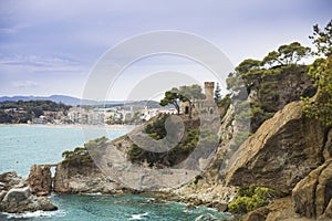 Plajan on the Costa Brava and city beach in Lloret de Mar, Spain. Sand and sea waves.