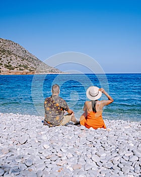 Plaka Lassithi with is traditional blue table and chairs and the beach in Crete Greece