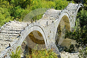 Plakidas arched stone bridge of Zagori region in Northern Greece. Iconic bridges were mostly built during the 18th and 19th